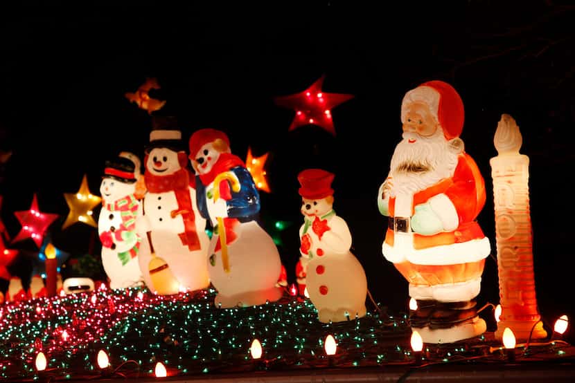Snowmen congregate with Santa atop Simmons' home in Old East Dallas.