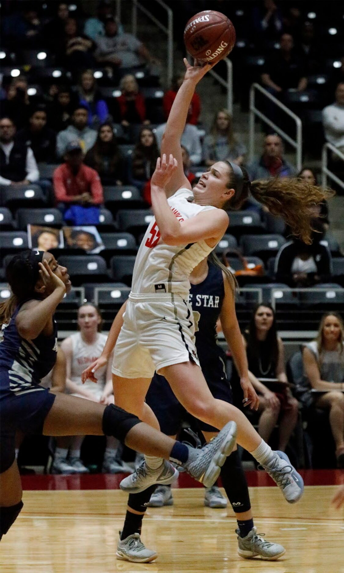 Liberty High School guard Kelsey Kurak (55) gets off a shot during the second half as...