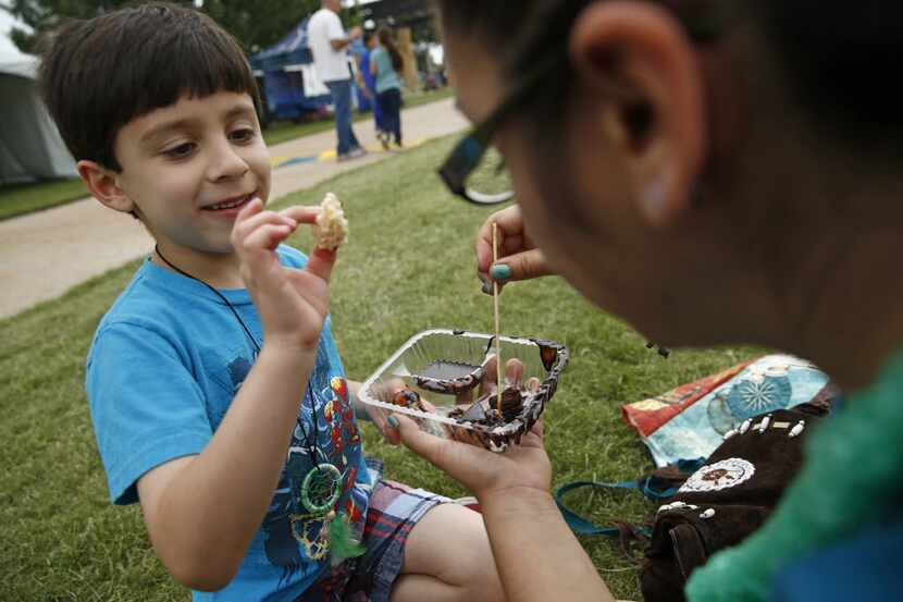 Kristina Deluna and her son Liam Deluna, 6, eat a dessert from The Melting Pot at Taste...