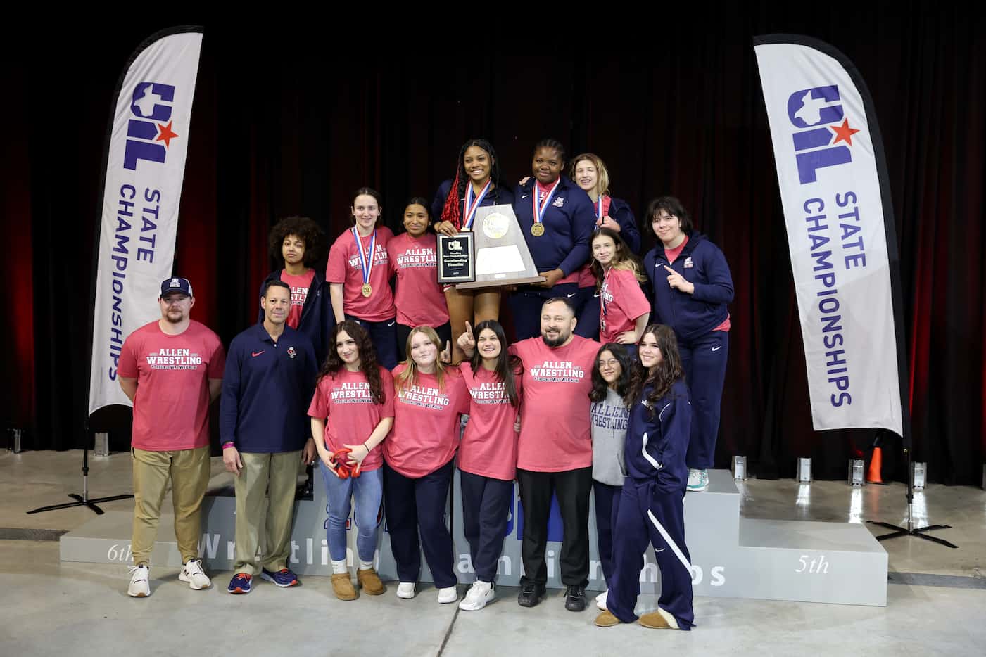 The Allen Girls Wrestling team poses for a photograph after winning the Girls 6A Team...