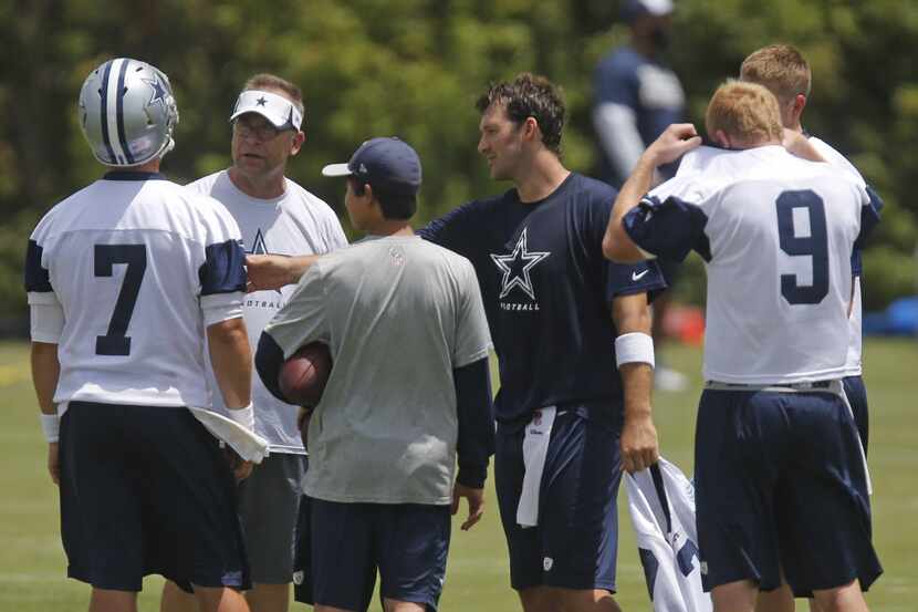 Dallas quarterback Tony Romo, blue shirt, trades jerseys with quarterback Caleb Hanie (7),...