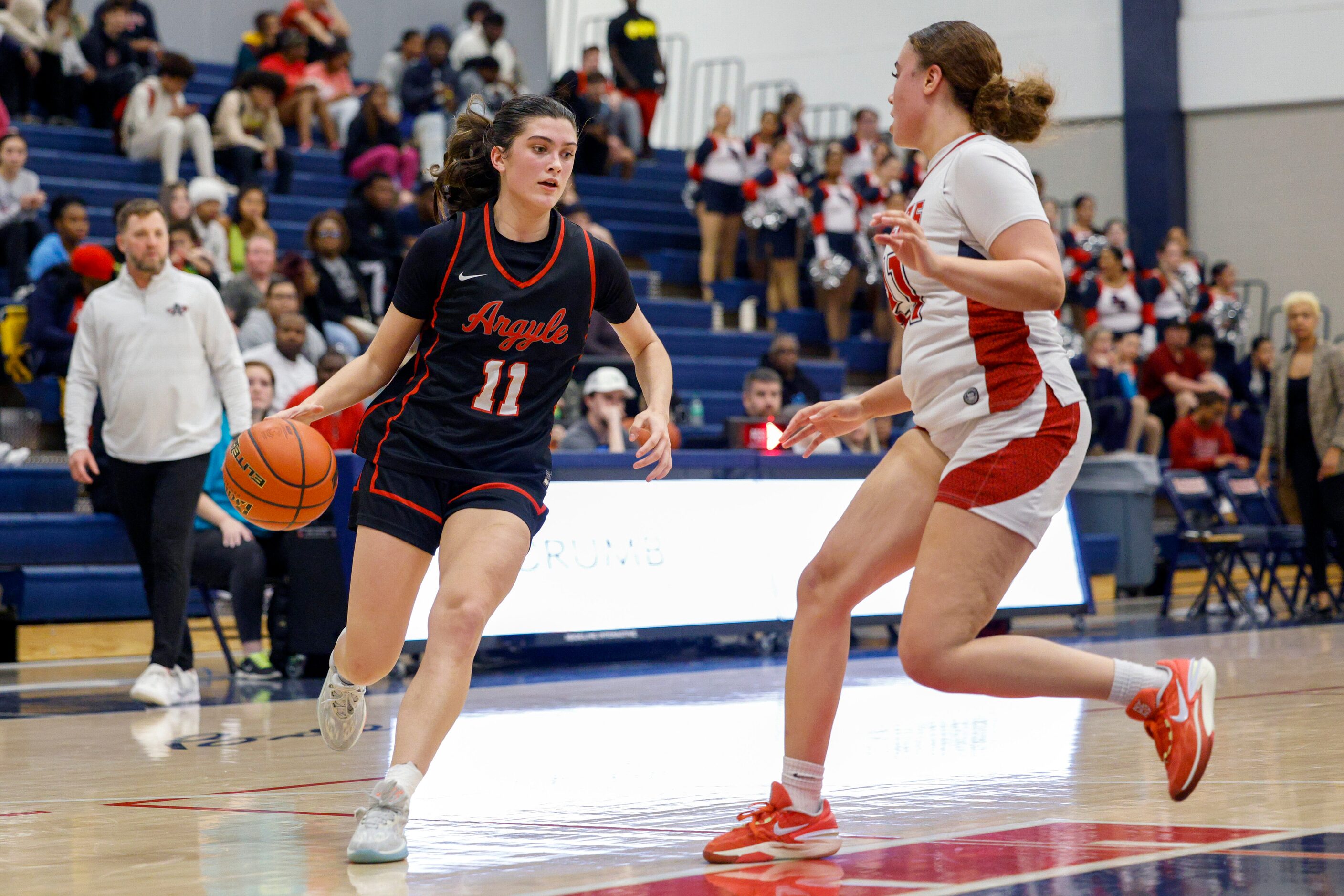 Argyle forward Samantha Bacon (11) drives to the basket against Denton Ryan center Aspen...