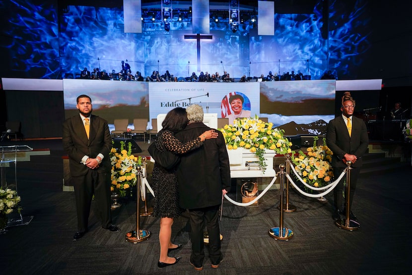 Lisa Sherron and Michael Thomas, who both worked for the congresswoman, embrace as they...