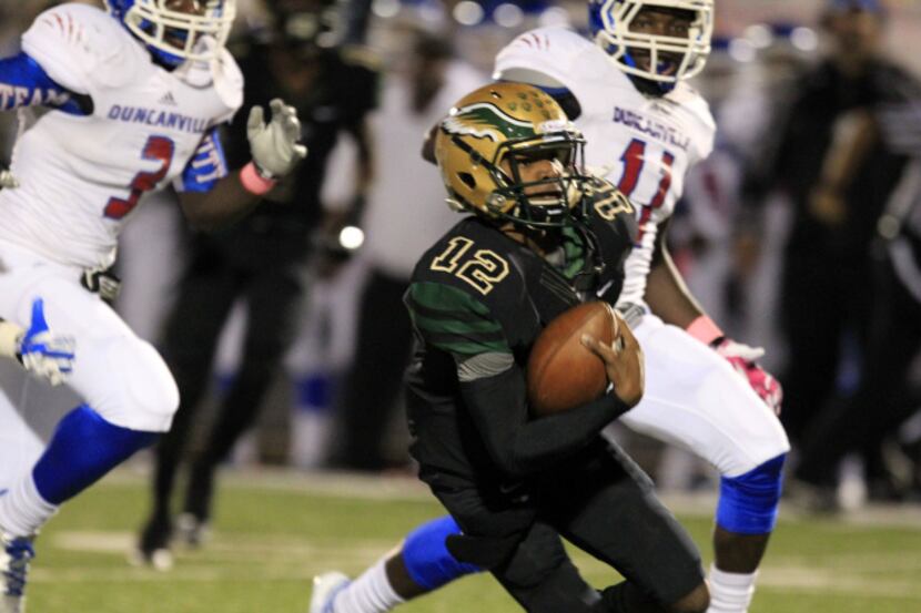 DeSoto High Desmon White (12) breaks loose on a long run to score the team's first...