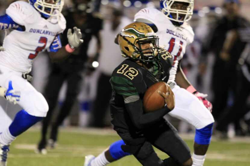 DeSoto High Desmon White (12) breaks loose on a long run to score the team's first...
