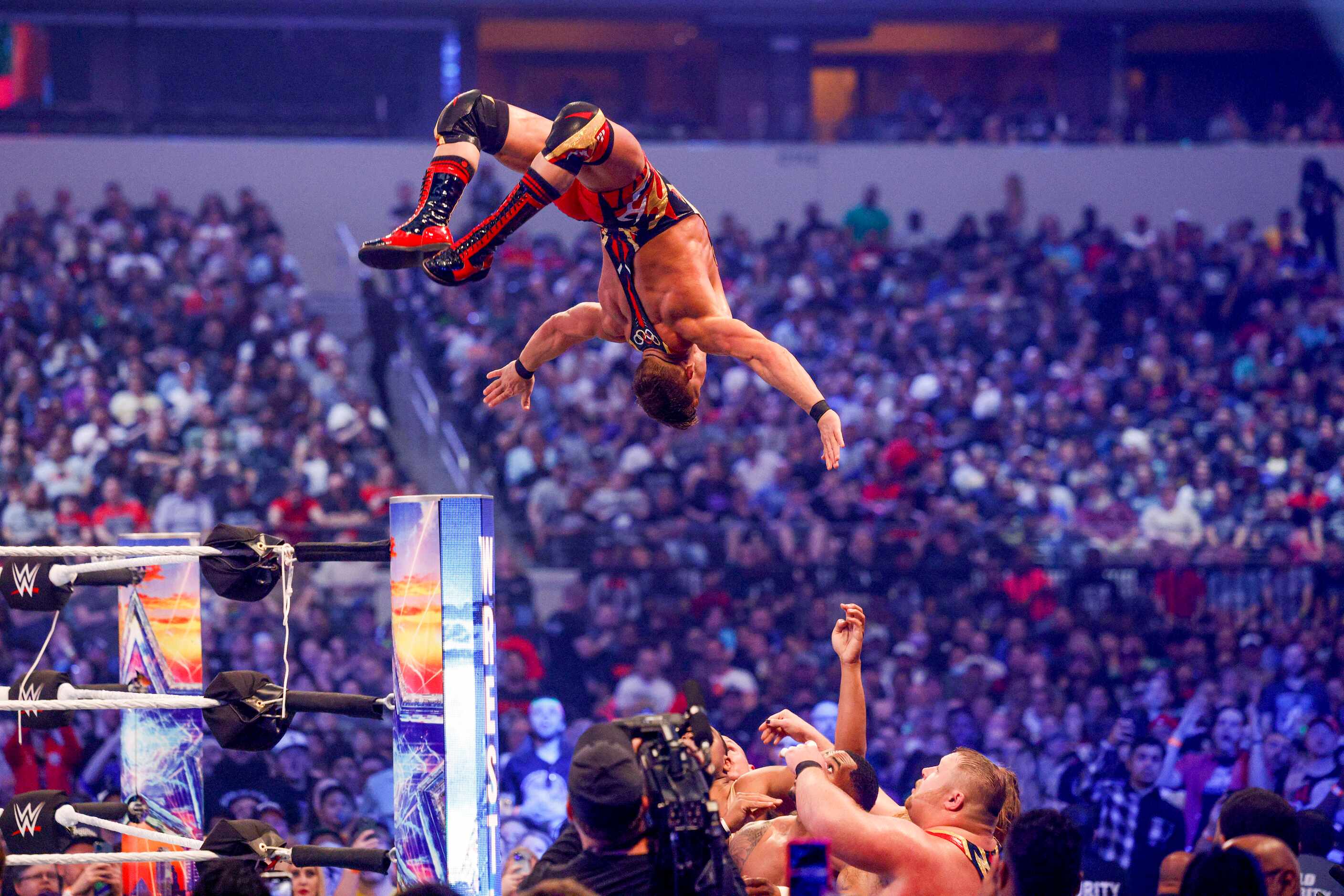 Chad Gable jumps off the top rope bduring a match at WrestleMania Sunday at AT&T Stadium in...
