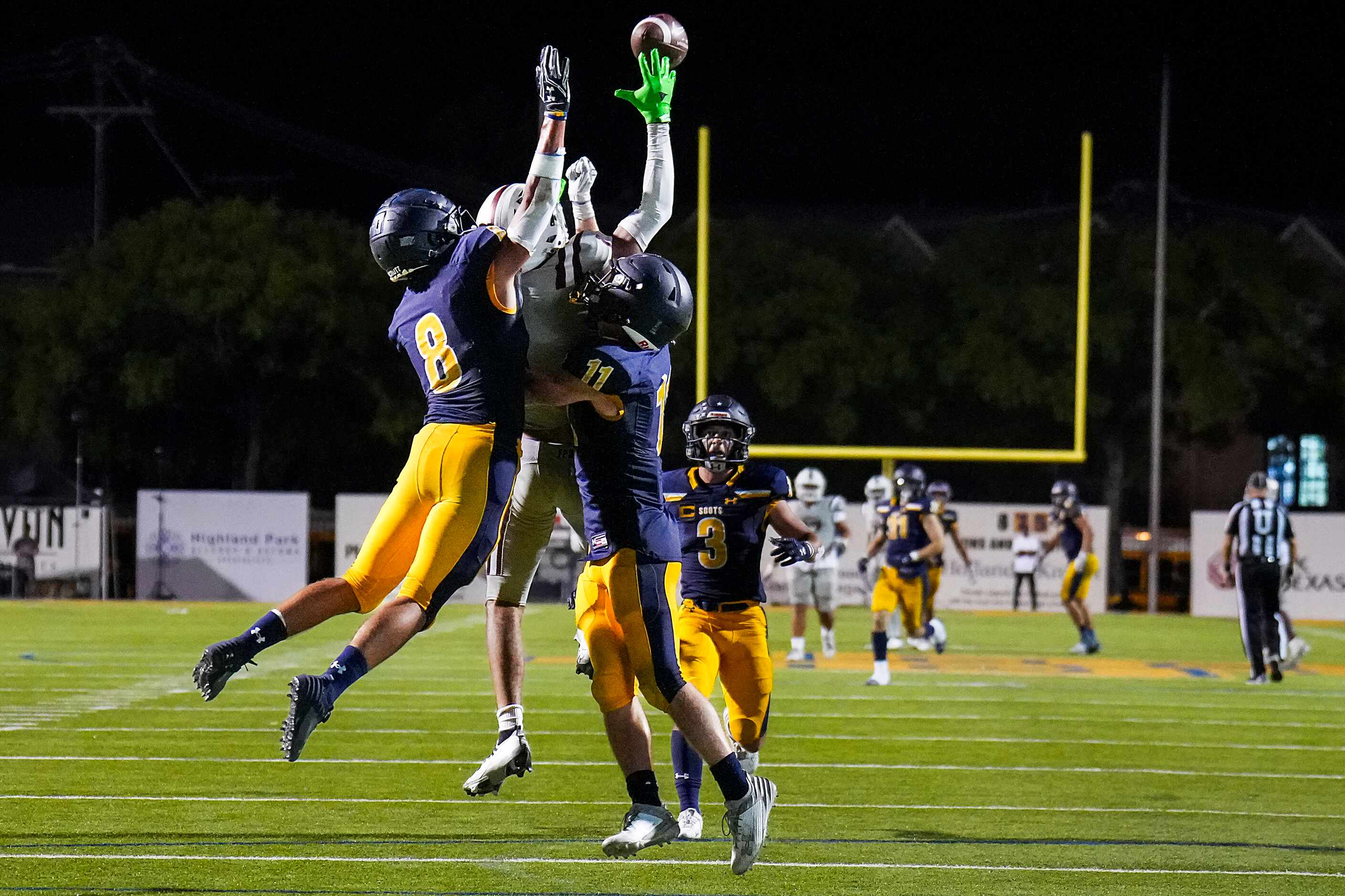 Highland Park’s Andrew Wade (8) and Wesley Winfield (11) break up a pass intended for...