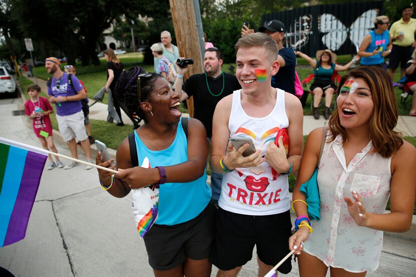 Friends (from left) Ekama Eni, Kyle Caldwell and Dafne Rojas cheered for floats at the  Alan...