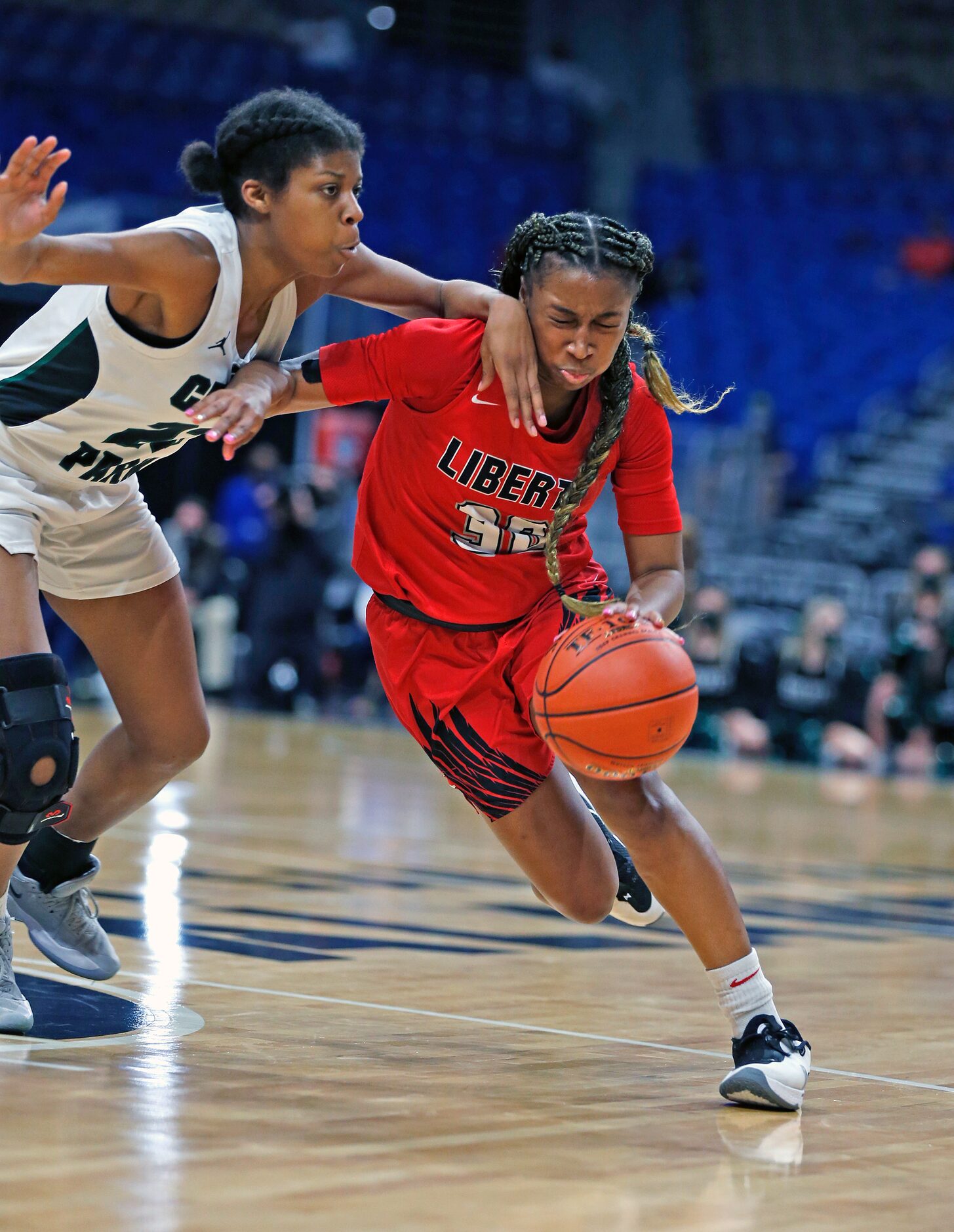 Frisco Liberty Jazzy Owens-Barnett #30 drives on Cedar Park Alisa Knight #23. Frisco Liberty...