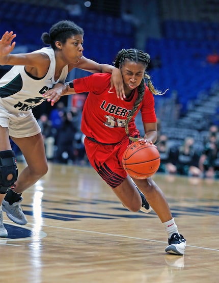 Frisco Liberty Jazzy Owens-Barnett #30 drives on Cedar Park Alisa Knight #23. Frisco Liberty...