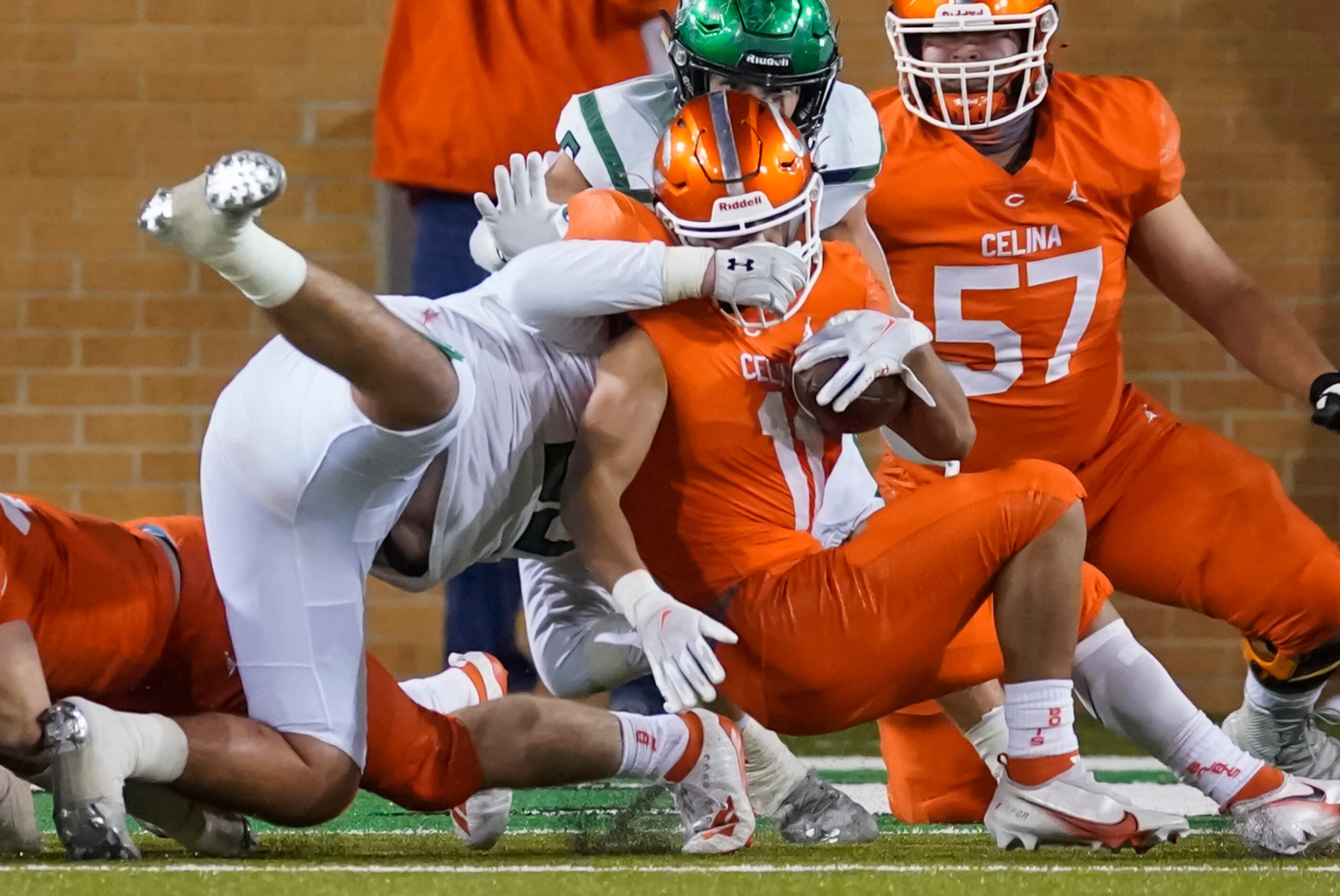 Celina running back Gabe Gayton (11) if brought down by Iowa Park defensive lineman Samuel...