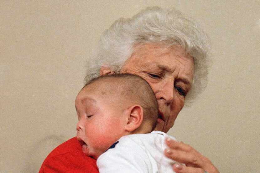 First lady Barbara Bush holds baby Donavan during a visit in 1989 to Grandma's House, which...