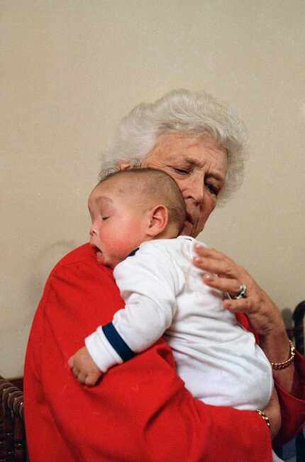 First lady Barbara Bush holds baby Donavan during a visit in 1989 to Grandma's House, which...