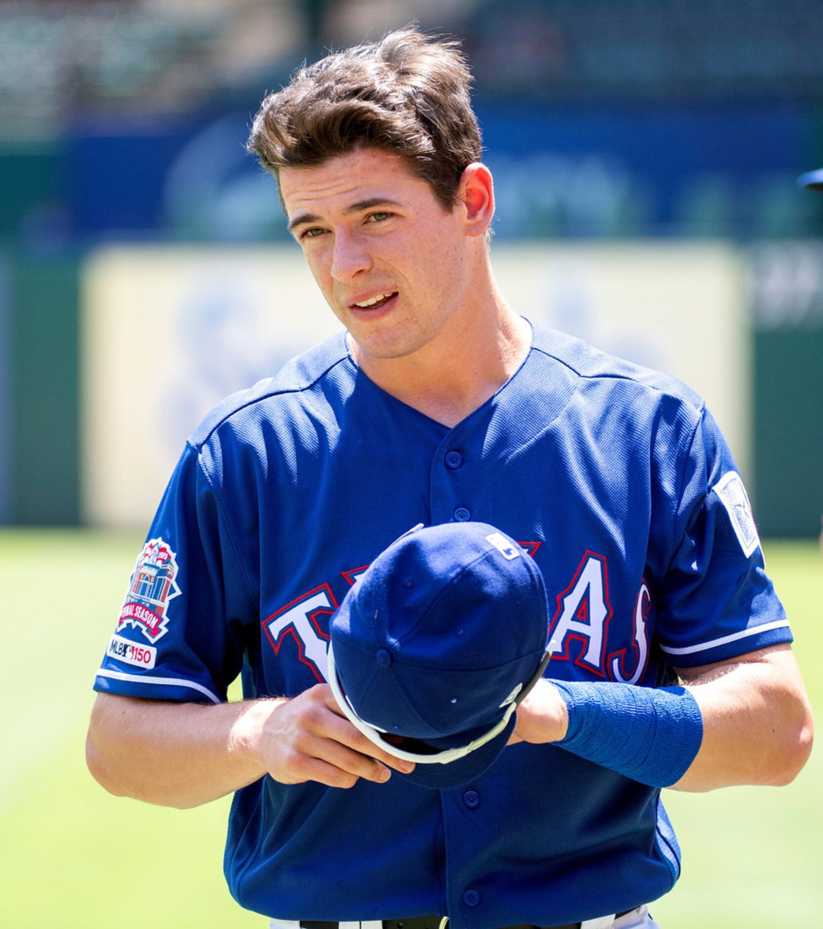 Texas Rangers' Nick Solak, in his major league debut, warms up before the first baseball...