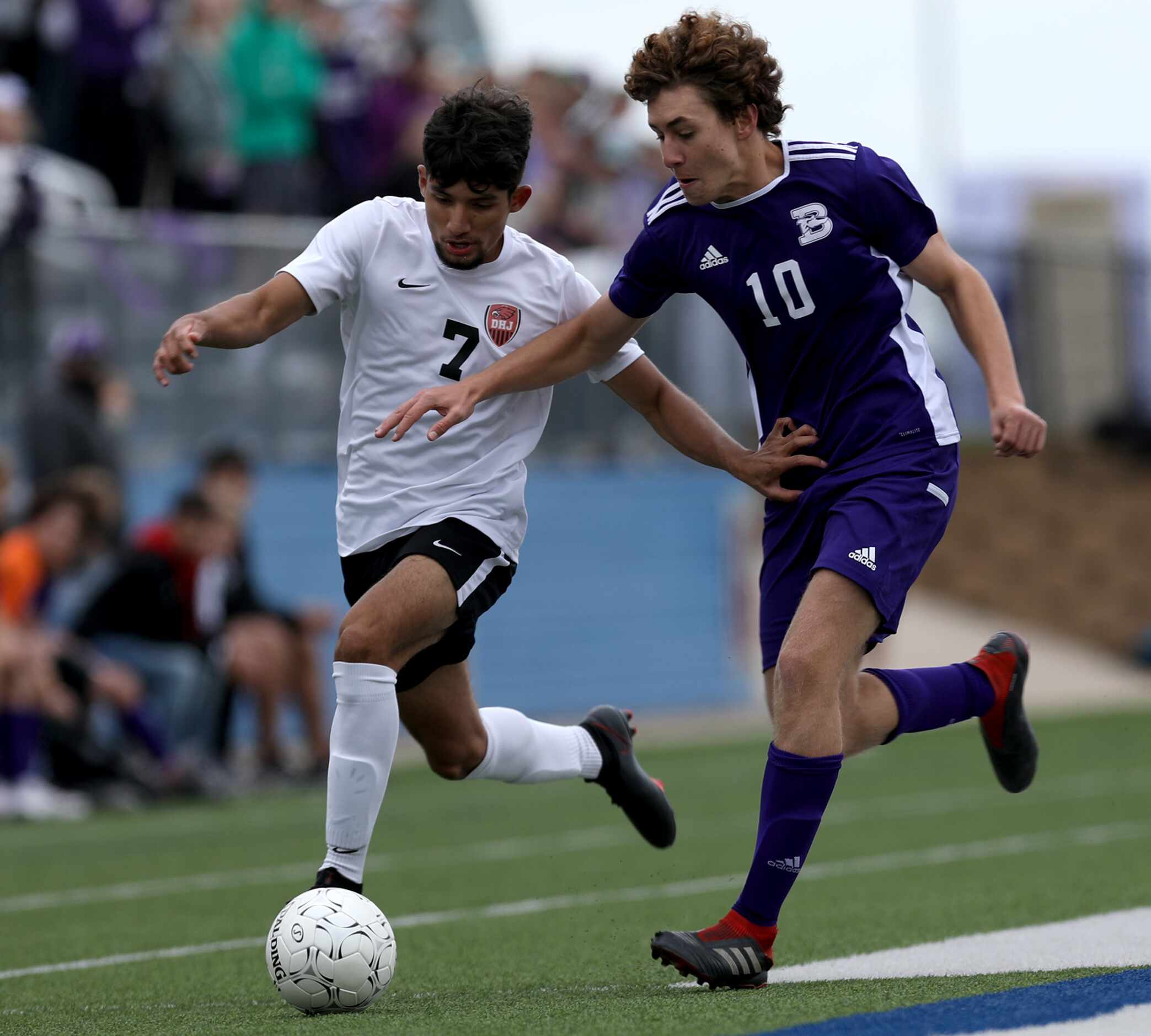 Fort Worth Diamond Hill-Jarvis' Luis Jaimes (7) and Boerne's Joe Ballenger (10) chase after...