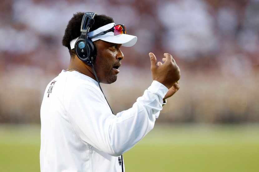 Texas A&M Aggies head coach Kevin Sumlin summons his players to the sidelines during a...