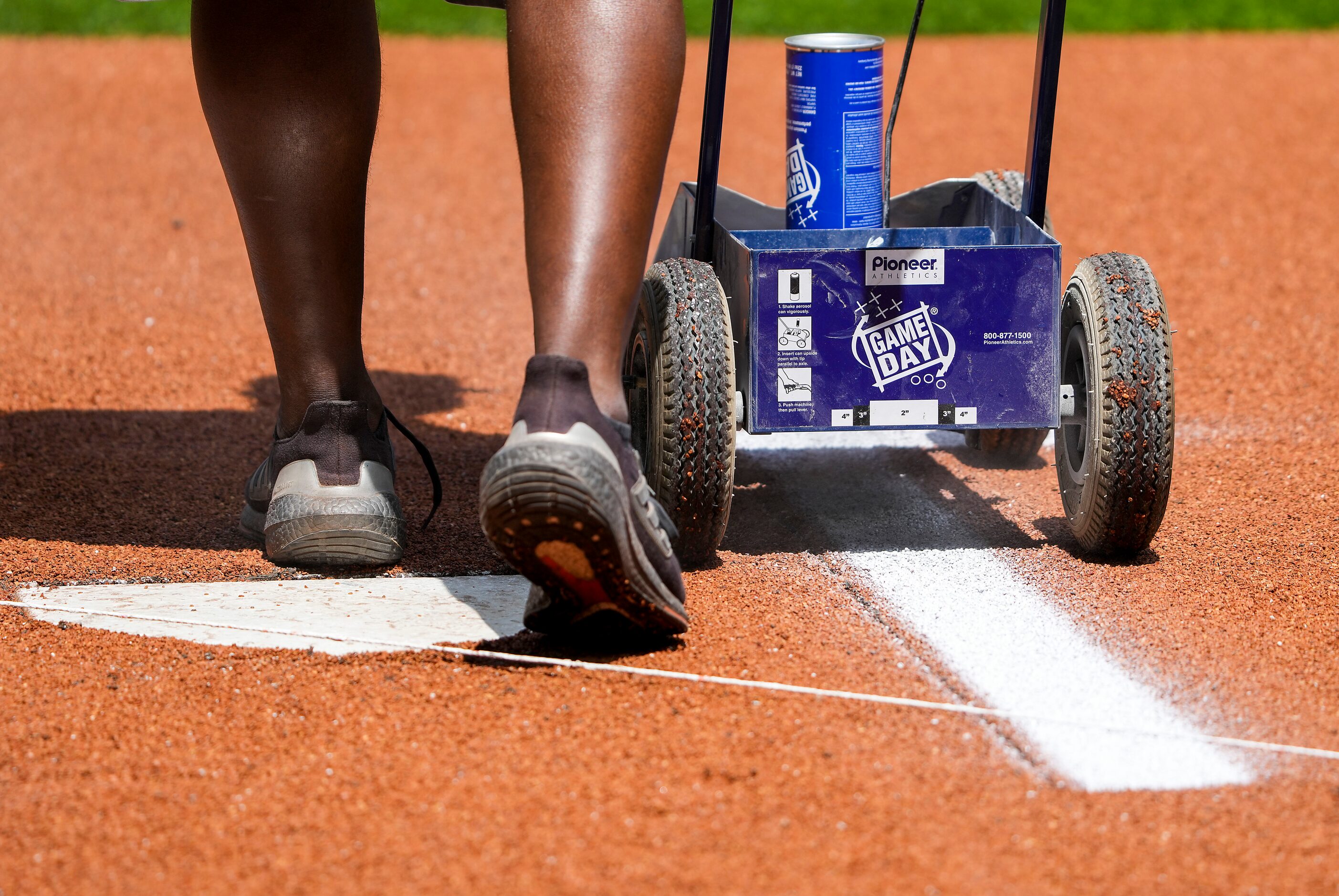 Groundskeepers stripe the field before the Texas Rangers home opener against the Colorado...