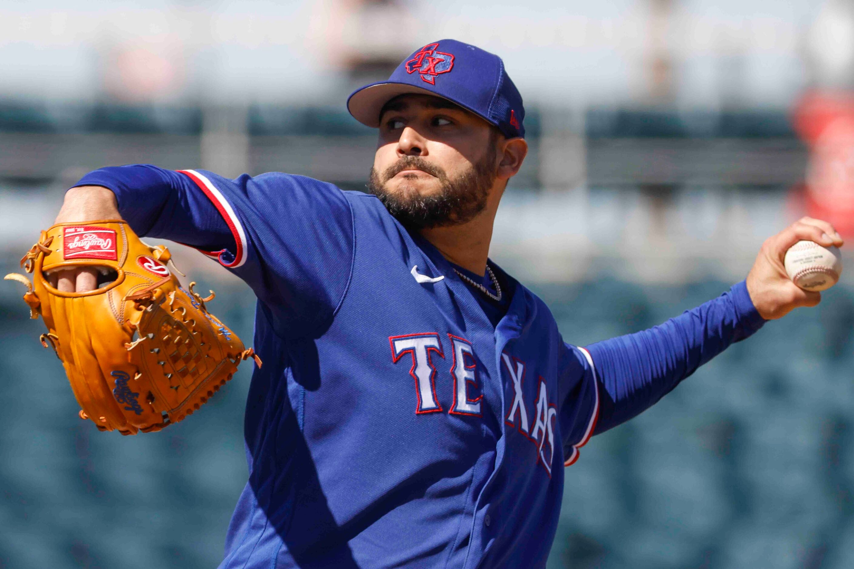 Texas Rangers Martín Pérez delivers a pitch during the first inning of a spring training...