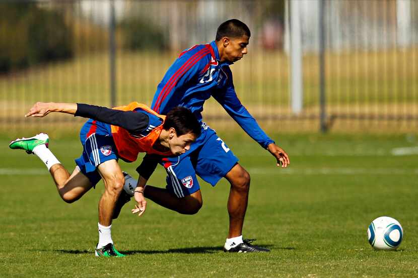 FC Dallas midfielder Eric Avila (left) and defender Moises Hernandez battle for possession...