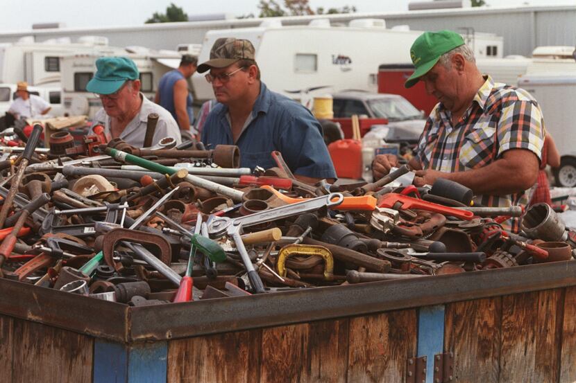 Men rummage through a huge container of used tools at a Canton First Monday Trade Days.