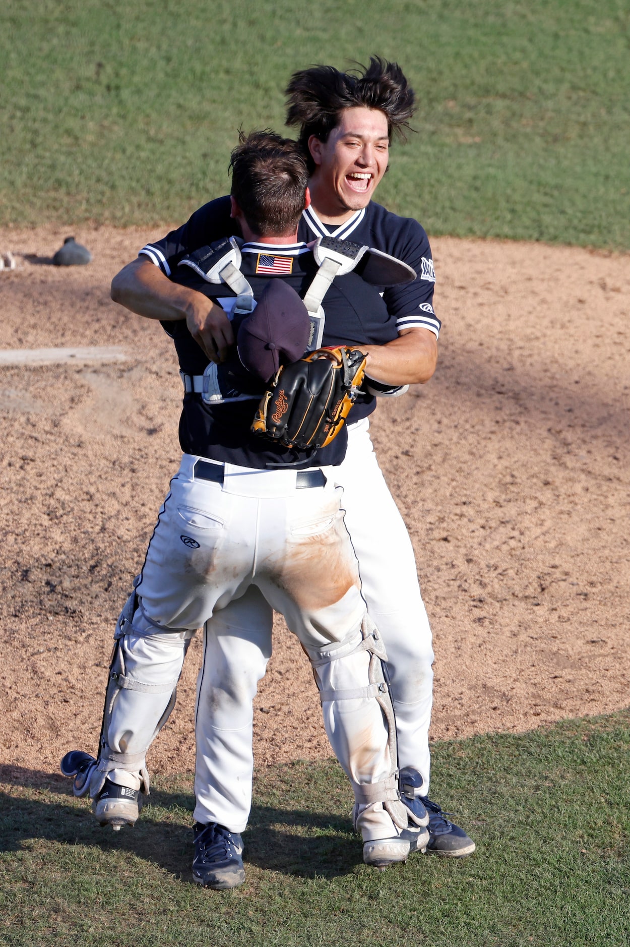 Dallas Baptist pitcher Dominic Hamel (27) and teammate and catcher Christian Boulware (12)...