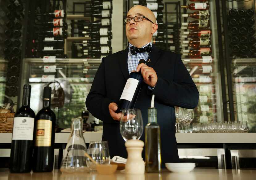 Richard Patino, general manager and wine director of Sachet restaurant, holds a bottle of...