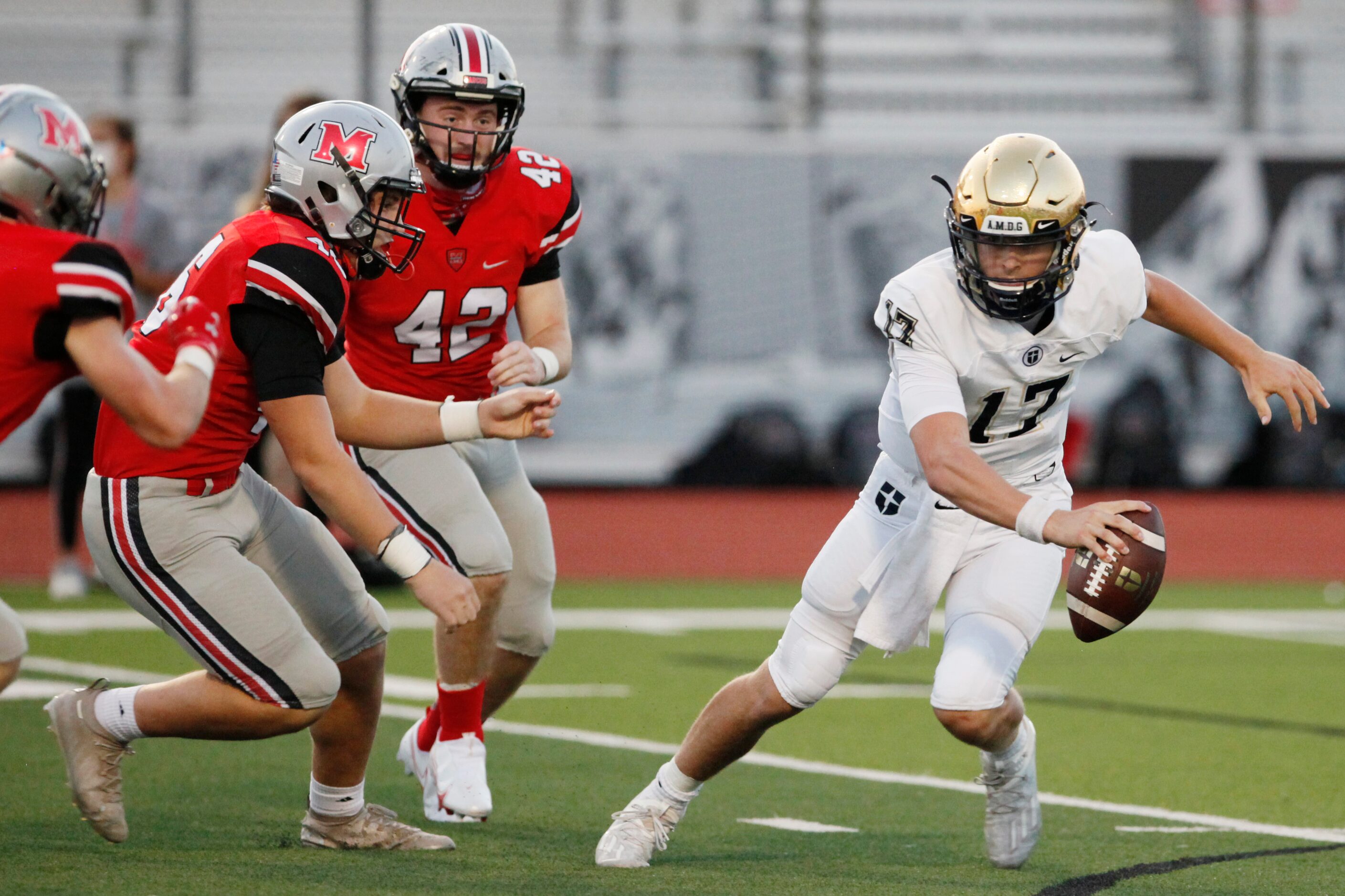 Jesuit junior quarterback Gage Roy (17) is pressured by Flower Mound Marcus defenders Mark...