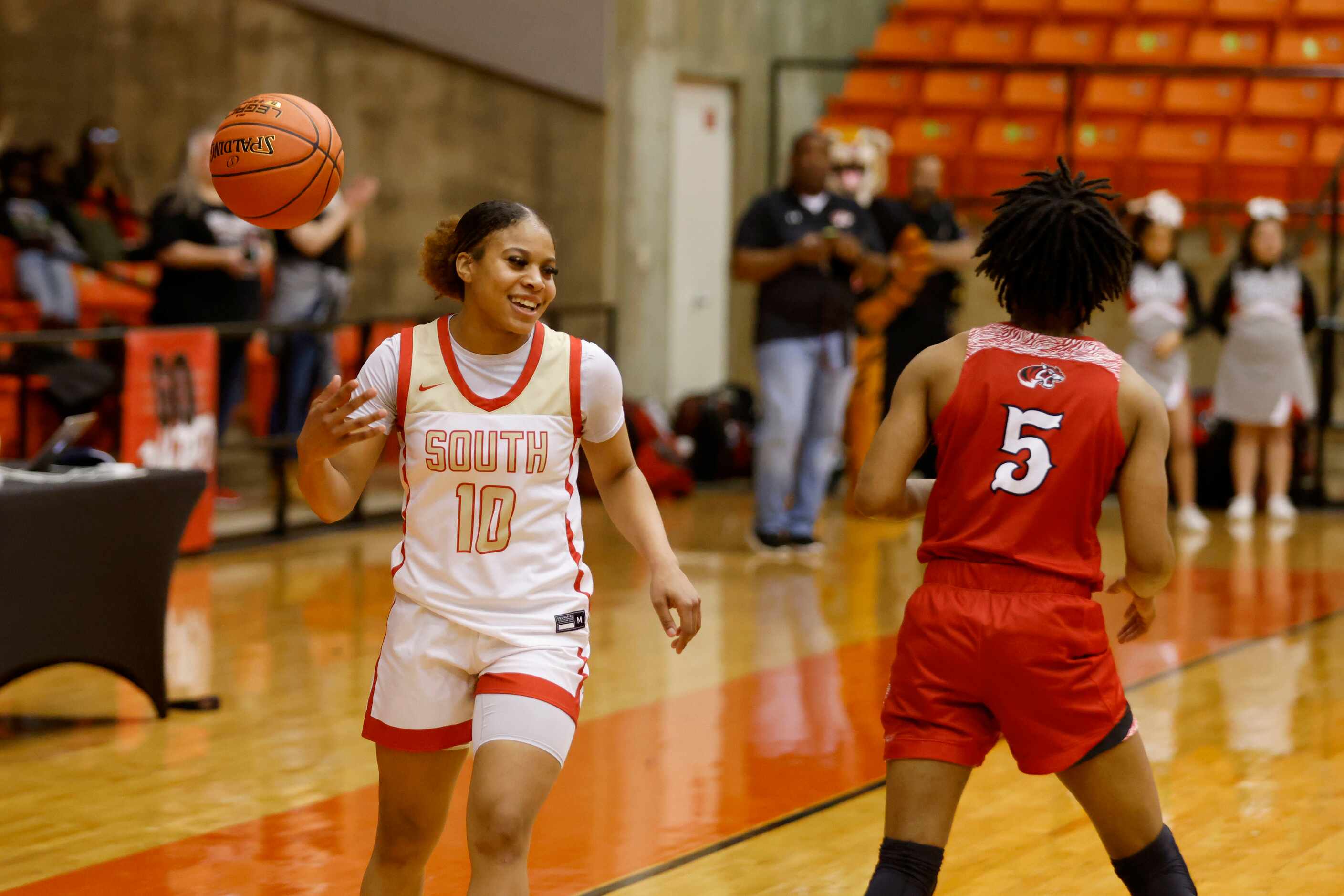 South Grand Prairie’s Victoria Dixon (10) tosses the ball away in front of Denton Braswell’s...