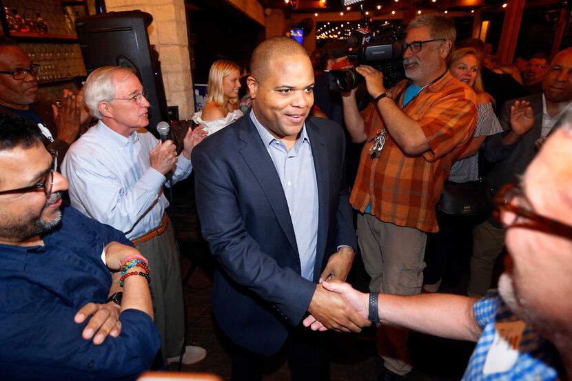 Dallas mayoral candidate and current State Representative Eric Johnson is congratulated by...