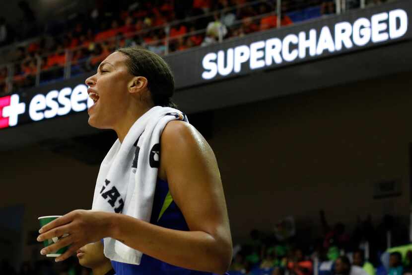 Dallas Wings center Liz Cambage (8) voices her support from the team bench during first half...