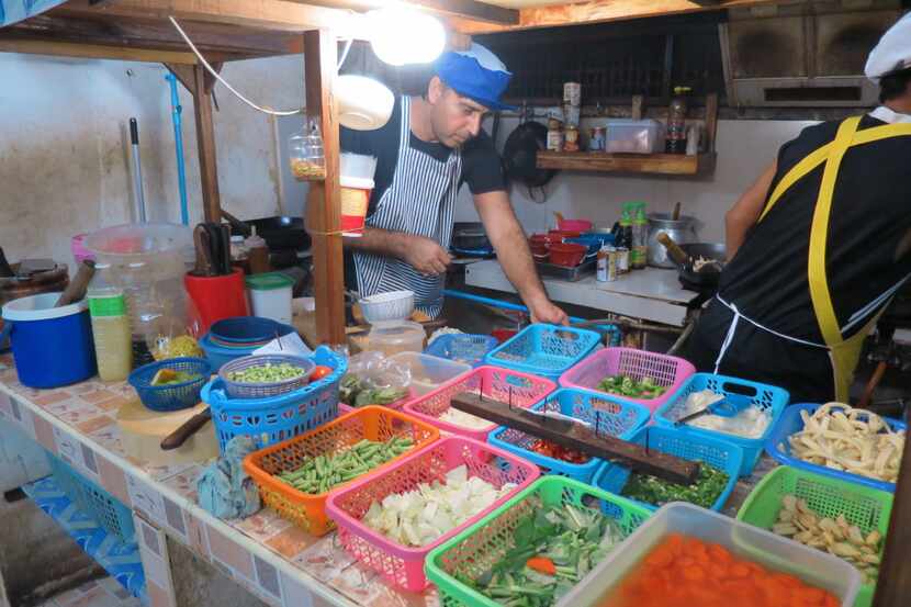 Baskets of fresh ingredients are prepped for use in  Thai dishes in the kitchen at Papaya...