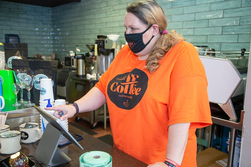 Angela Walterscheid rings up a customer at the coffee shop.