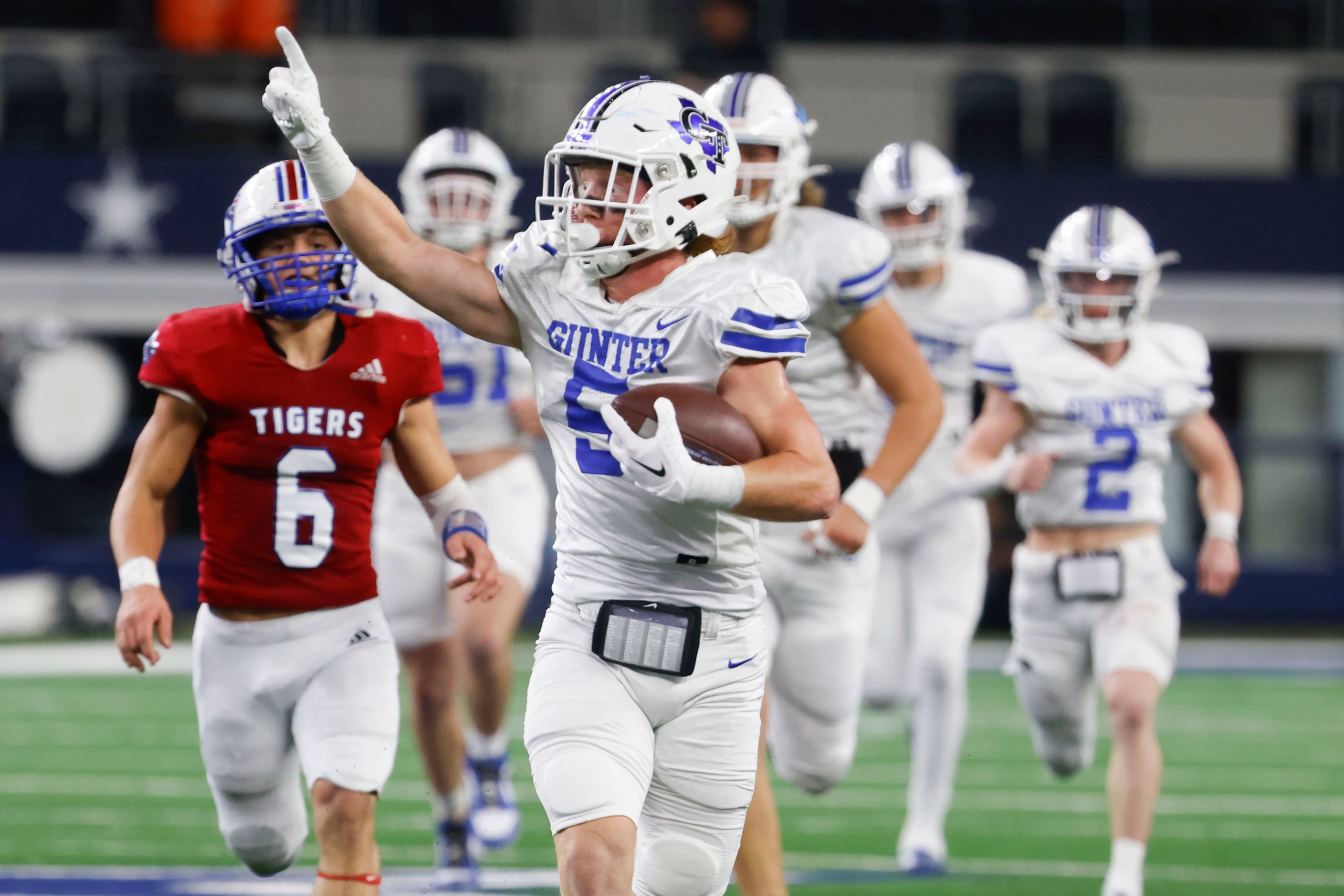 Gunter High’s Cannon Lemberg (5) points towards the sideline as he runs for a touchdown...