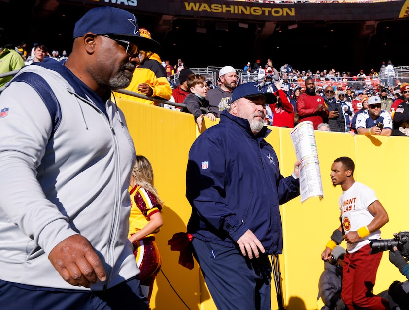 Dallas Cowboys head coach Mike McCarthy walks onto the field before the start of an NFL game...