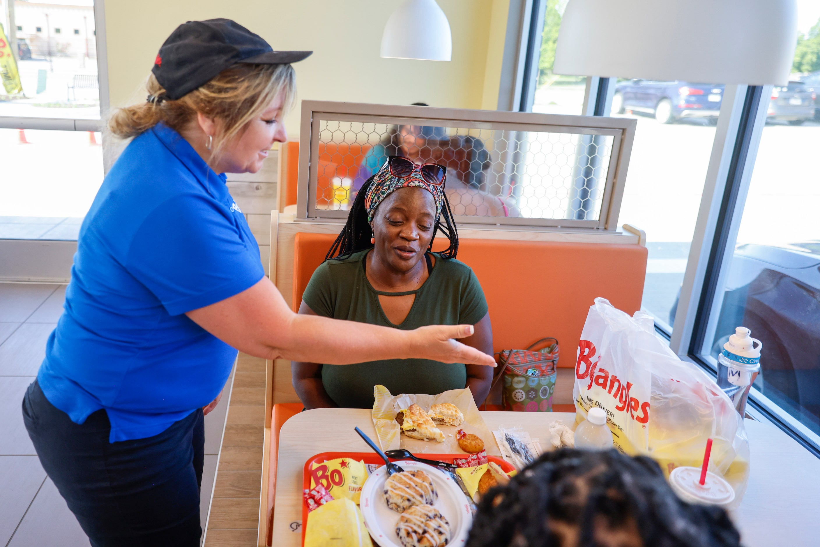 Manager Lisa Piontkwoski gives a free meal to Yvonne Beacham (back) for her birthday during...