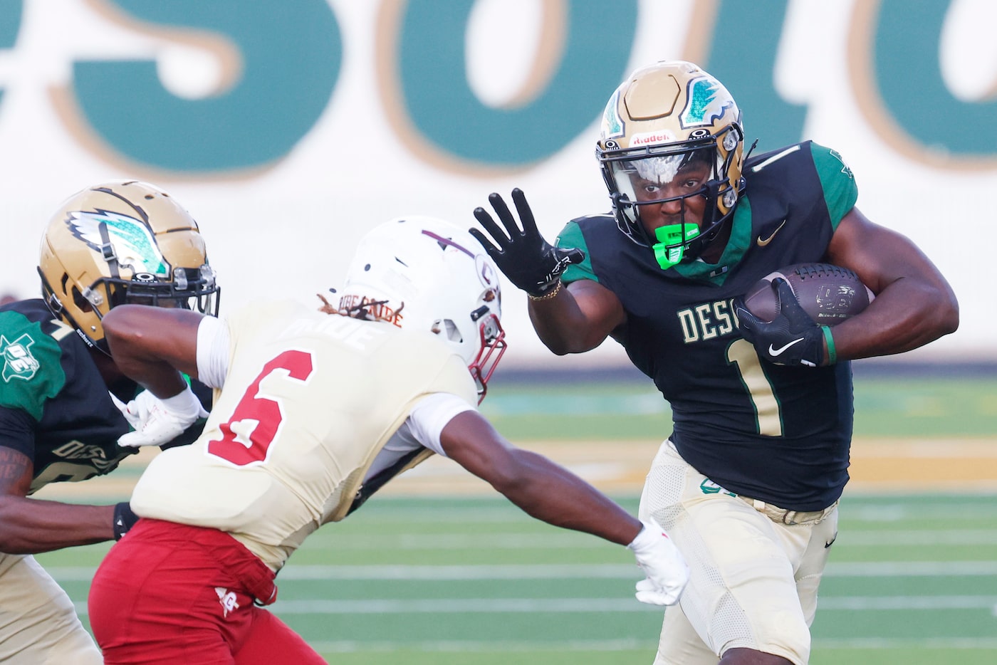 DeSoto High’s Deondrae Riden Jr. (1) runs past Creekside High School (Ga.) Eric Paul (6)...