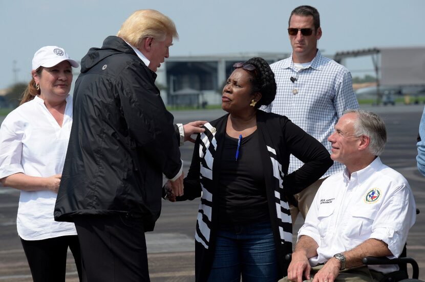 President Donald Trump talks with Rep. Sheila Jackson Lee, D-Texas, and Texas Gov. Greg...