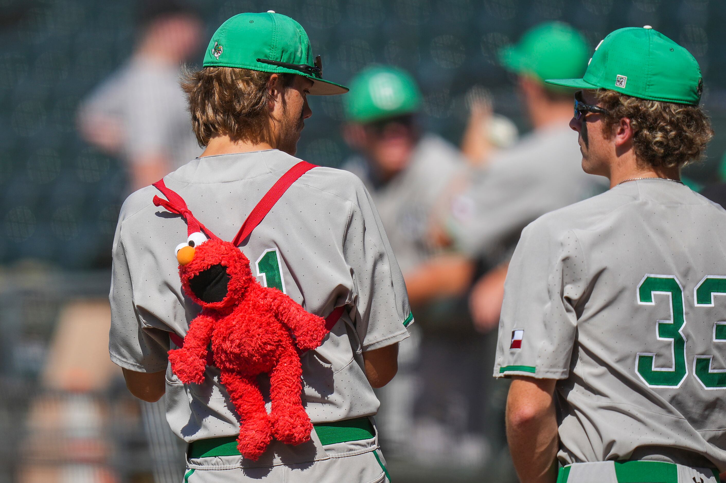 Southlake Carroll pitcher Grant Wright wears an Elmo doll on his back during the first...