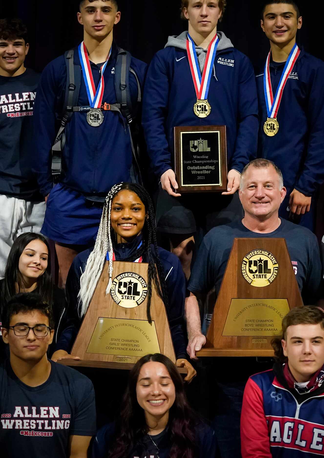 Allen wrestler Jasmine Robinson (left) and coach Jerry Best hold the championship trophies...