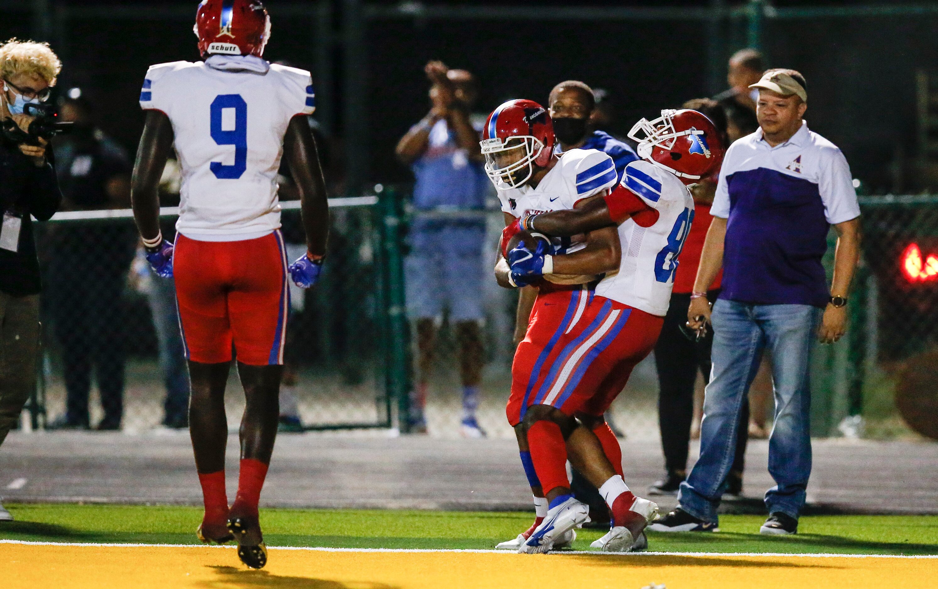 Duncanville sophomore running back Caden Durham, center, is congratulated by freshman wide...