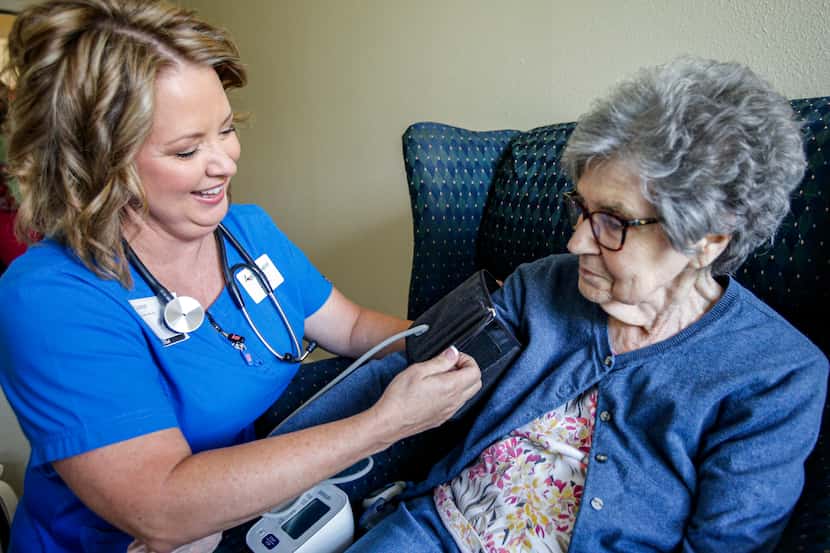 Ardent Hospice registered nurse Jody Lyons, left, checks Mary Jane Turner's blood pressure...