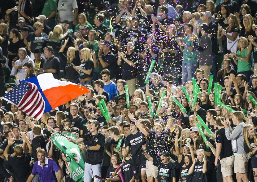 Confetti fills the air as Southlake Carroll fans celebrate a 57-yard touchdown reception by...