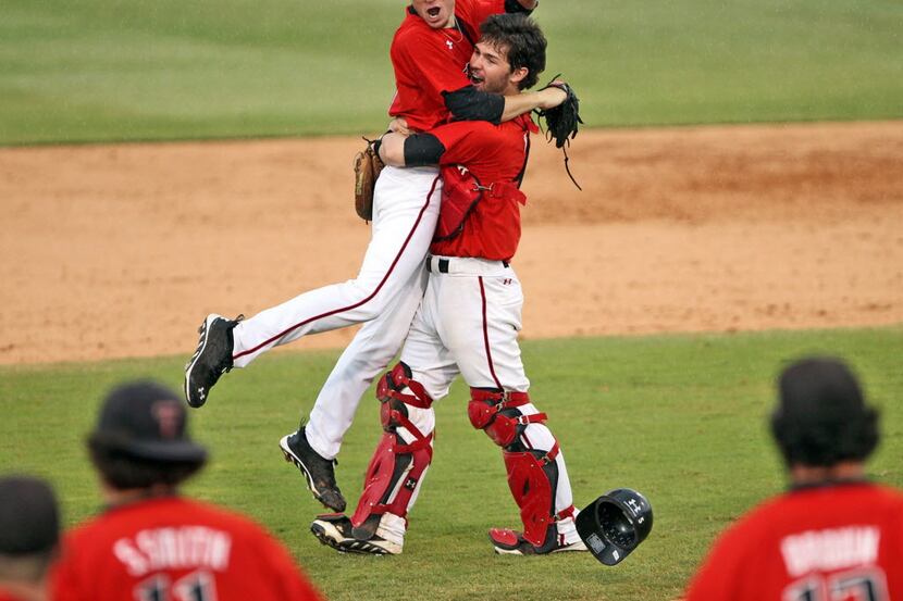 Texas Tech Red Raiders catcher Hunter Redman gives winning pitcher Cameron Smith a hug at...