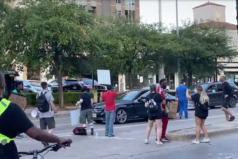 This still image from a video provided by Jordan Smith shows an encounter between protesters...