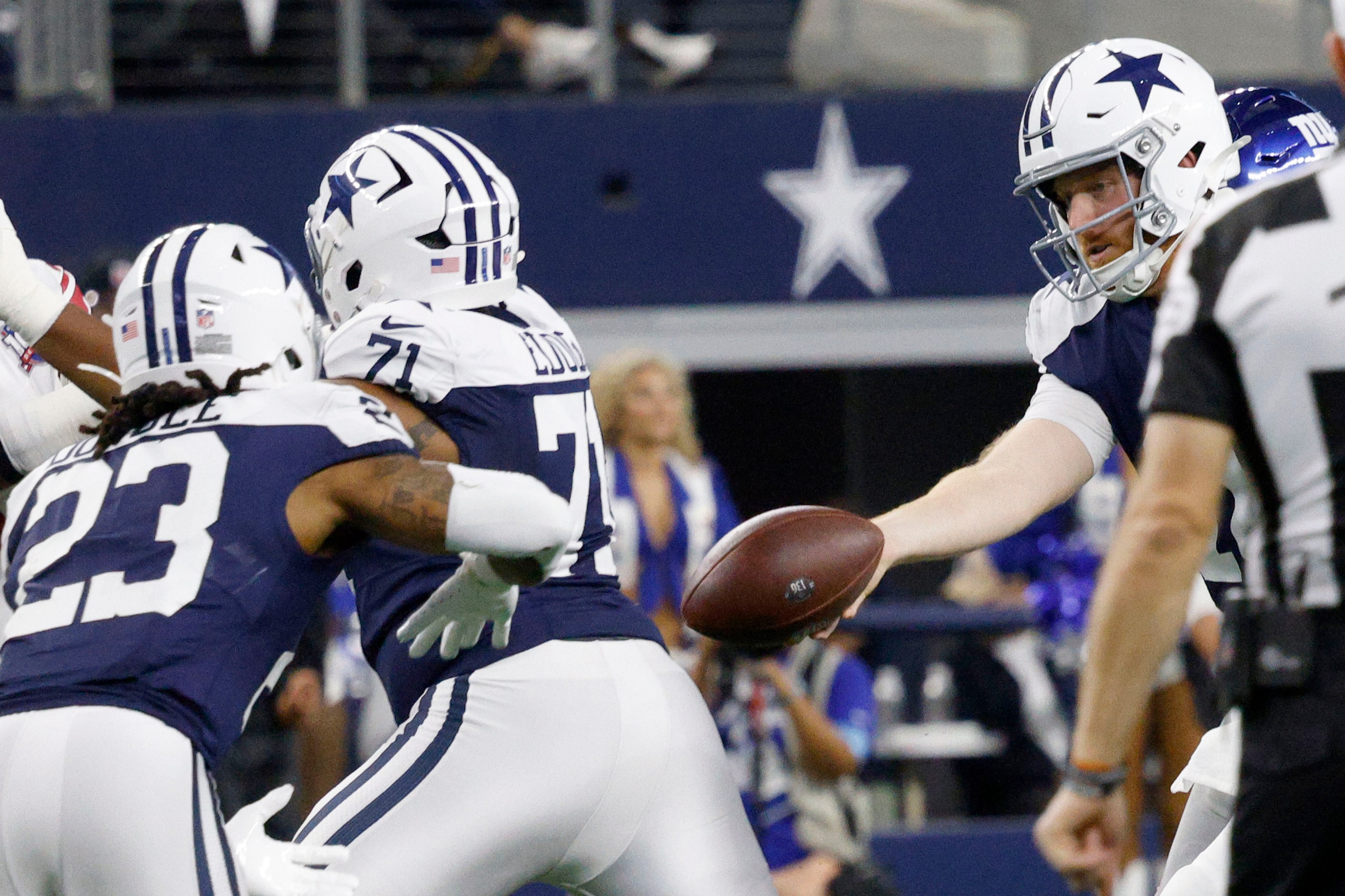 Dallas Cowboys quarterback Cooper Rush (10), right, hands off to Dallas Cowboys running back...