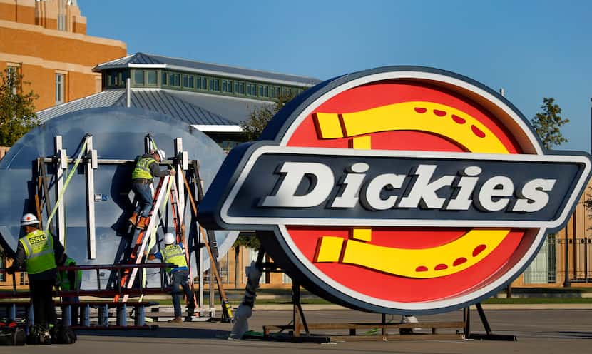 A crew from SSC Signs and Lighting preps four large Dickies logos to be lifted into place...