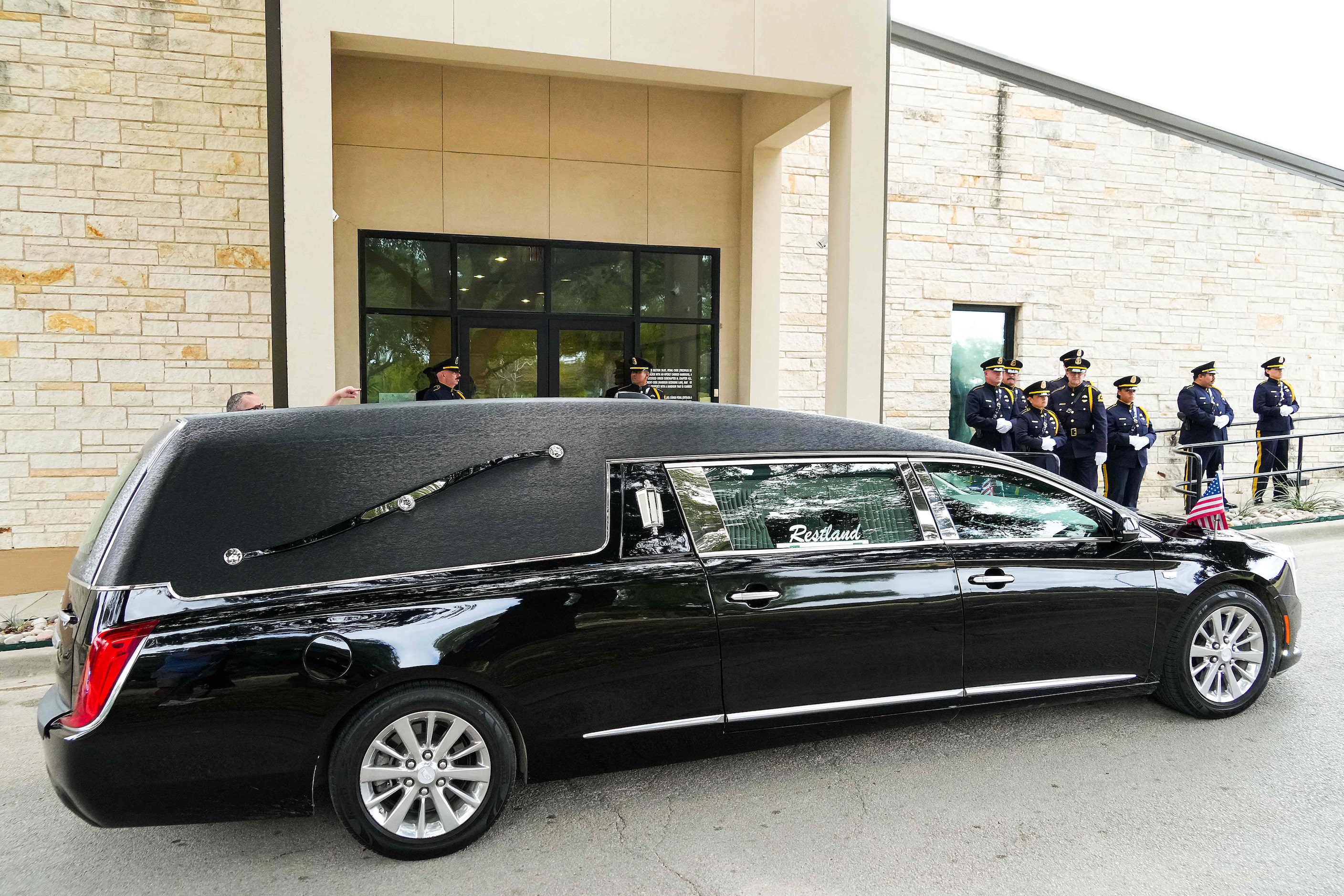 A hearse arrives at Restland Funeral Home as fallen Dallas Police officer Darron Burks is...