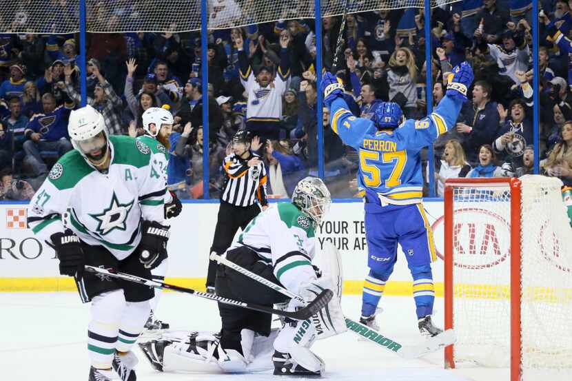 The St. Louis Blues' David Perron, right, reacts after teammate Patrik Berglund scored the...