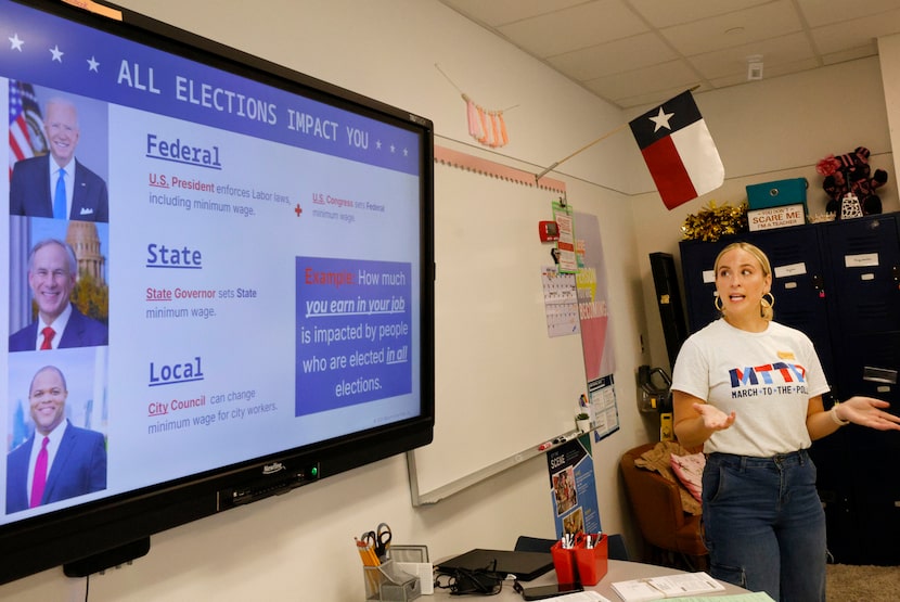 Hannah Kessler, a volunteer with March to the Polls, a voter registration group, talks to...