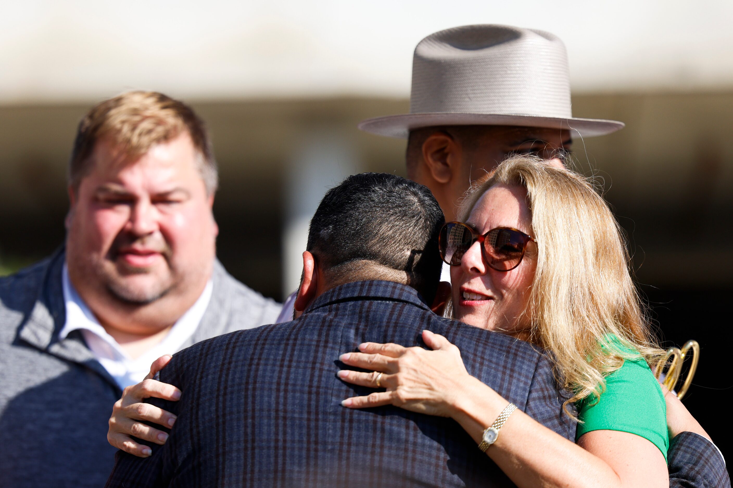 City council member Jesse Moreno (left), hugs president and CEO of Downtown Dallas Parks...